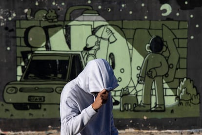 Painter and graffiti artist Imon Boy in front of one of his works in Vélez-Málaga, Spain, on January 2.