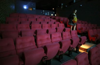 A woman leaves Madrid's Renoir Cuatro Caminos movie theater, which closed on Monday.