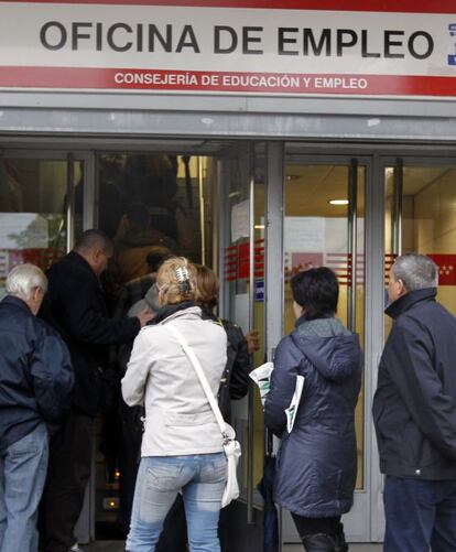 Ciudadanos hacen cola ante la oficina de empleo de un barrio de Madrid.