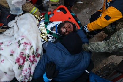 Turkish rescue workers carry Ergin Guzeloglan, 36, to an ambulance after pulled him out from a collapsed building five days after an earthquake in Hatay, southern Turkey, early Saturday, Feb. 11, 2023.