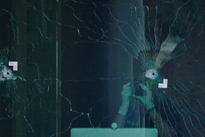 Investigators inspect bullet holes at the scene of a mass shooting at Old National Bank in downtown Louisville, Kentucky, U.S. April, 10, 2023