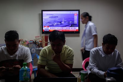 Taiwanese residents watch a news broadcast about a military drill conducted by the Chinese military around the Taiwan Strait, in Taipei, Taiwan, 19 August 2023.