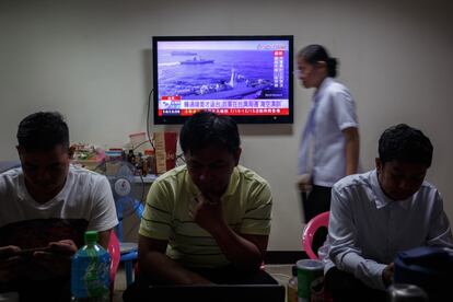 Taiwanese residents watch a news broadcast about a military drill conducted by the Chinese military around the Taiwan Strait, in Taipei, Taiwan, 19 August 2023.