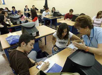 Alumnos de secundaria atienden las explicaciones de su profesora.