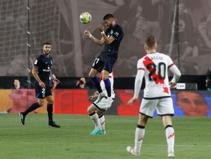 Carrasco pone un centro de cabeza durante el partido de la Liga entre el Atlético de Madrid y el Rayo Vallecano, este domingo.