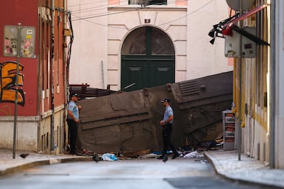 Agentes de policía permanecen a los restos del funicular siniestrado tras el descarrilamiento, este jueves en Lisboa. 