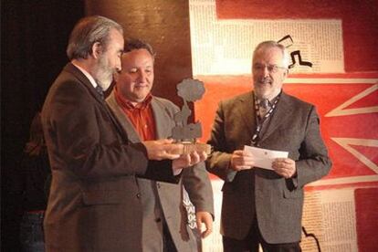Millán recibe el premio de manos del alcalde de Huesca, Fernando Elboj. A la derecha, 'Forges'.