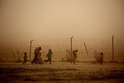 Niños sirios durante una tormenta de arena en el campo de refufiados temporal en Ain Issa, que acoge a personas que han huido del Estado Islámico, a 50 km de Raqa, el 10 de noviembre de 2016.