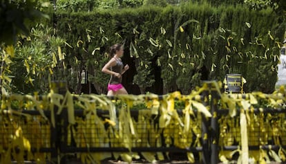 Una joven corre en una zona repleta de lazos amarillos, en el parque de la Ciutadella. 