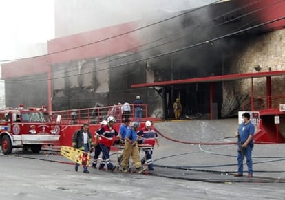 Emergency services taking care of an injured person after the attack on the Casino Royal in Monterrey, Mexico.