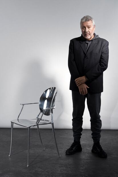 Philippe Starck posa junto a la silla que ha creado para Dior.