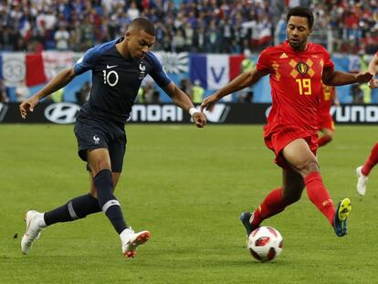 France's Kylian Mbappe, left, and Belgium's Moussa Dembele challenge for the ball during the semifinal match between France and Belgium at the 2018 soccer World Cup in the St. Petersburg Stadium in, St. Petersburg, Russia, Tuesday, July 10, 2018. (AP Photo/Frank Augstein)
