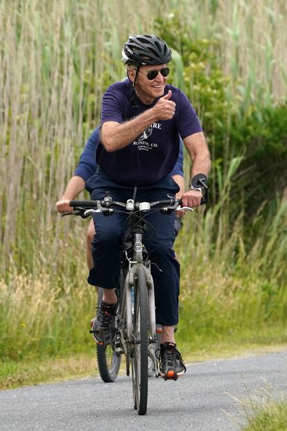 El presidente Joe Biden monta en bicicleta por un parque en Delaware.