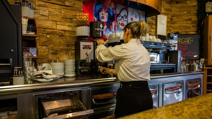 Una camarera pone un café en un establecimiento de A Coruña.