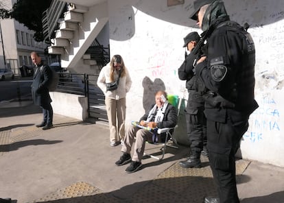 La policía ayuda a un hombre que se lastimó mientras esperaba para ver la Cristina Kirchner afuera de su edificio.
