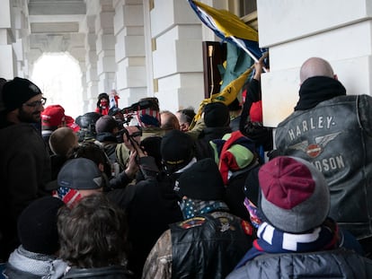 Insurrectionists loyal to President Donald Trump try to open a door of the U.S. Capitol as they riot in Washington, Jan. 6, 2021.