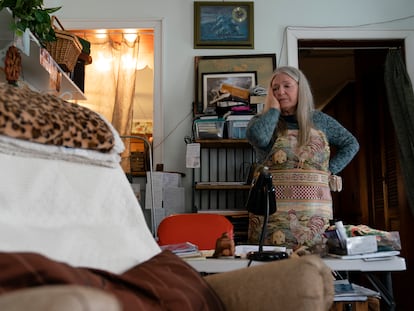 Nancy Rose, who contracted Covid-19 in 2021 and exhibits long-haul symptoms including brain fog and memory difficulties, pauses while organizing her desk space, Tuesday, Jan. 25, 2022, in Port Jefferson, N.Y.
