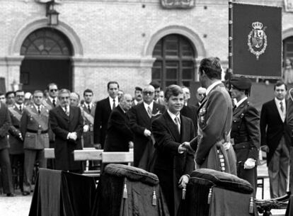 1 de marzo de 1981. El rey Juan Carlos  da la paz al príncipe Felipe, en el acto de jura de nuevo la bandera española con sus compañeros de la XIV promoción de la Academia General de Zaragoza, al cumplirse los 25 años de su ingreso, días después del intento de golpe de Estado del 23-F.  En su discurso el Rey llamó a la reflexión a políticos y militare. 