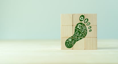 Carbon Footprint, zero emission concept. Carbon ecological footprint symbols on wooden cubes with eco friendly icons. Sustainable development strategy. Environmental, climate change concept. CSR ESG