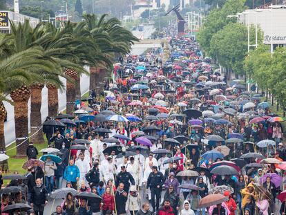 Numerosas personas peregrinan bajo la lluvia durante la Romería de la Santa Faz, este jueves.