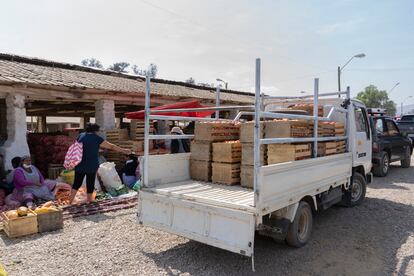 A truck arrives with vegetables at the market.