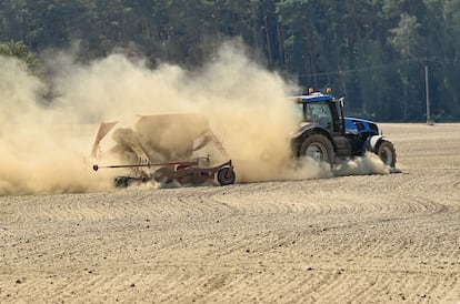 A farmer drives his tractor over dry farmland in Brandenburg, Germany, last August.