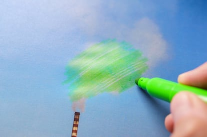 Man painting green pollution from a chimney. greenwashing malpractice concept