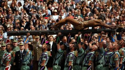 Cospedal contempla a los legionarios levantando la imagen del Cristo de la Buena Muerte en Málaga. 