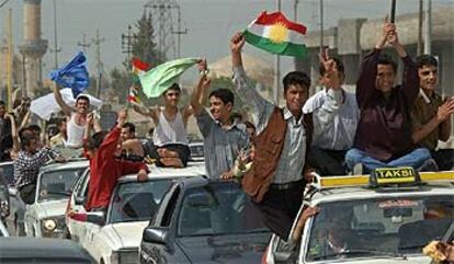 Jóvenes kurdos celebran la caída de Bagdad por las calles de la ciudad de Erbil, al norte de Afganistán.