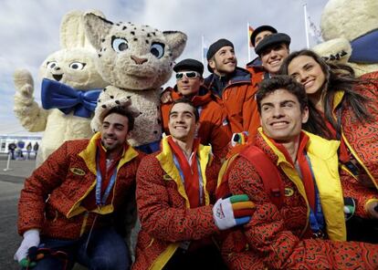 Members of the Spain team pose for a picture with some mascots during a welcoming ceremony at the 2014 Winter Olympics. 