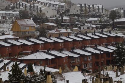 Nieve sobre los tejados, a primera hora de este martes en Manzanares el Real. SANTI BURGOS