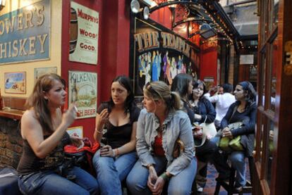 Tres jóvenes en un <i>pub</i> en Dublín (Irlanda).