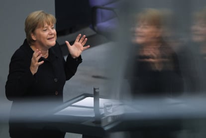 Merkel se dirige a los parlamentarios en la sesión ayer en el Bundestag.