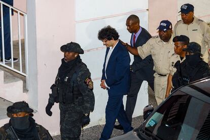 Samuel Bankman-Fried is escorted by police after being denied bail.