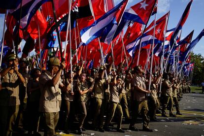 Soldados marchan con banderas nacionales durante las celebraciones del Primero de Mayo en La Habana, Cuba.