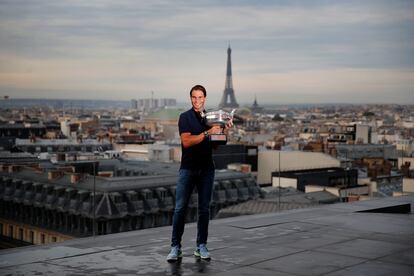 Spain's Rafael Nadal poses with his trophy during a photo call on the rooftop of Galeries Lafayette, Monday, Oct. 12, 2020, after winning Sunday the final match of the French Open tennis tournament against Serbia's Novak Djokovic in three sets, 6-0, 6-2, 7-5 at the Roland Garros stadium. (AP Photo/Francois Mori)