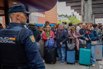 Viajeros esperando noticias de los trenes retrasados en la estación de Atocha, la mañana de este lunes.