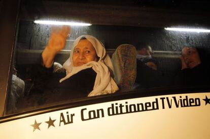 Una mujer saluda mientras sale de Gaza para visitar a un familiar.