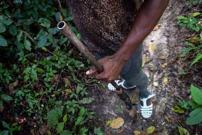 Ahmed Fofana hunts for bushmeat. His gun belonged to his grandfather and is reinforced with masking tape.
