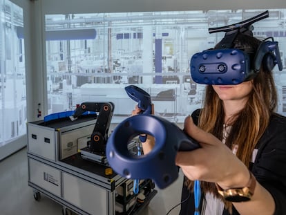 A woman demonstrates the use of Virtual Reality in factory planning at the Chemnitz University of Technology in Germany.