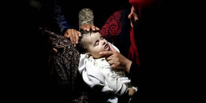 Relative mourns as she carries the body of eight-month-old Palestinian infant Laila al-Ghandour, who died after inhaling tear gas during a protest against U.S embassy move to Jerusalem at the Israel-Gaza border, during her funeral in Gaza City