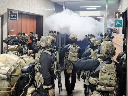 People react as police close the gate of the National Assembly, after South Korean President Yoon Suk Yeol declared martial law, in Seoul, South Korea, December 4, 2024. 