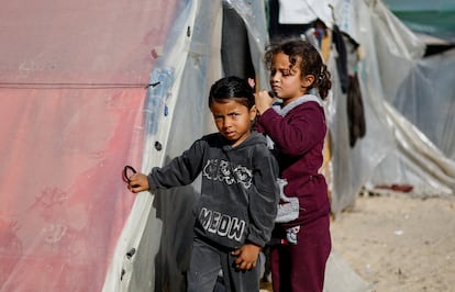 Una niña palestina desplazada peinaba a otra en un campamento en Rafah, en el sur de la franja de Gaza, este lunes. 