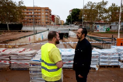 Guillermo Lujan, alcalde de Aldaia, conversa este miércoles con un operario ante una barrera de sacos de arena colocados en previsión de nuevas lluvias.