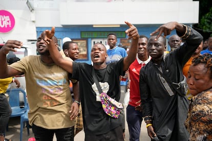 People celebrates after Eeectoral officials announce a result from of the polling station in Lagos, Nigeria, Saturday, March 18, 2023.