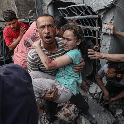 GAZA STRIP - MAY 18: Search and rescue teams rescue a Palestinian girl from under the rubble after the Israeli army attacked a building at the Jabalia Refugee Camp in Gaza Strip on May 18, 2025. (Photo by Abdalhkem Abu Riash/Anadolu via Getty Images)