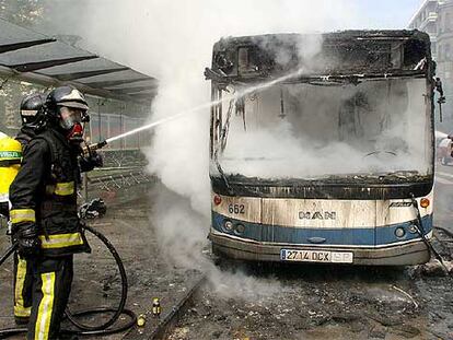 Los bomberos sofocan las llamas del autobús incendiado en San Sebastián en un ataque de violencia callejera.