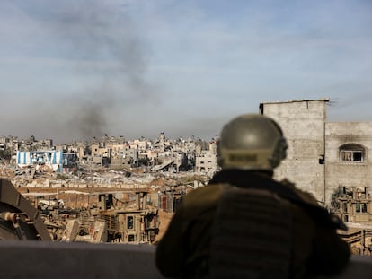An Israeli soldier observes the destruction caused by the military offensive in Gaza City, on January 8.