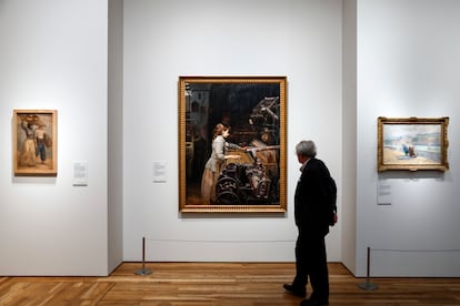 Un hombre pasa junto a 'La niña obrera' de Joan Planella.