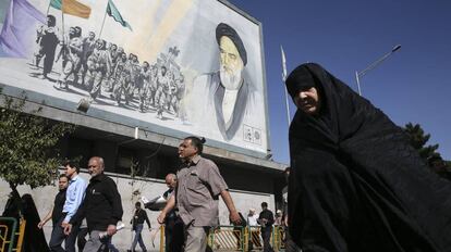 Iran&iacute;es pasan frente a una pintura del ayatol&aacute; Jomeini en Teher&aacute;n, Ir&aacute;n.